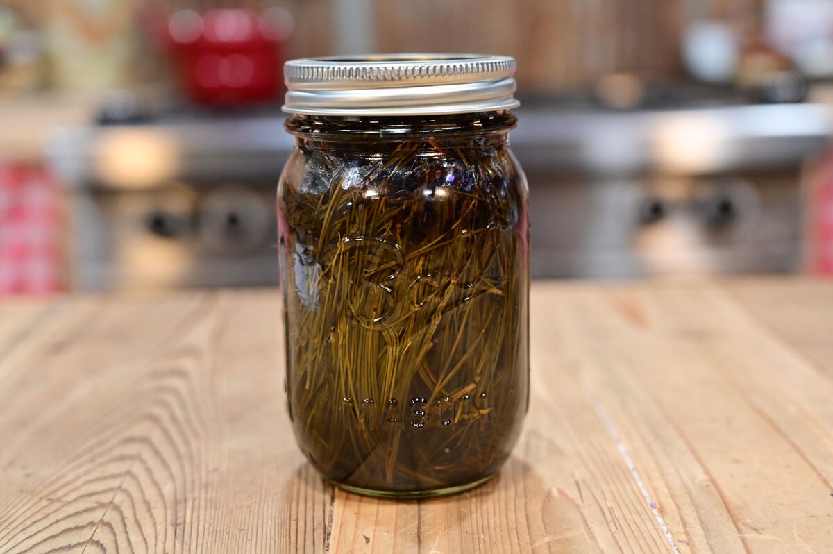 A pint-sized Mason jar filled with pine oil.