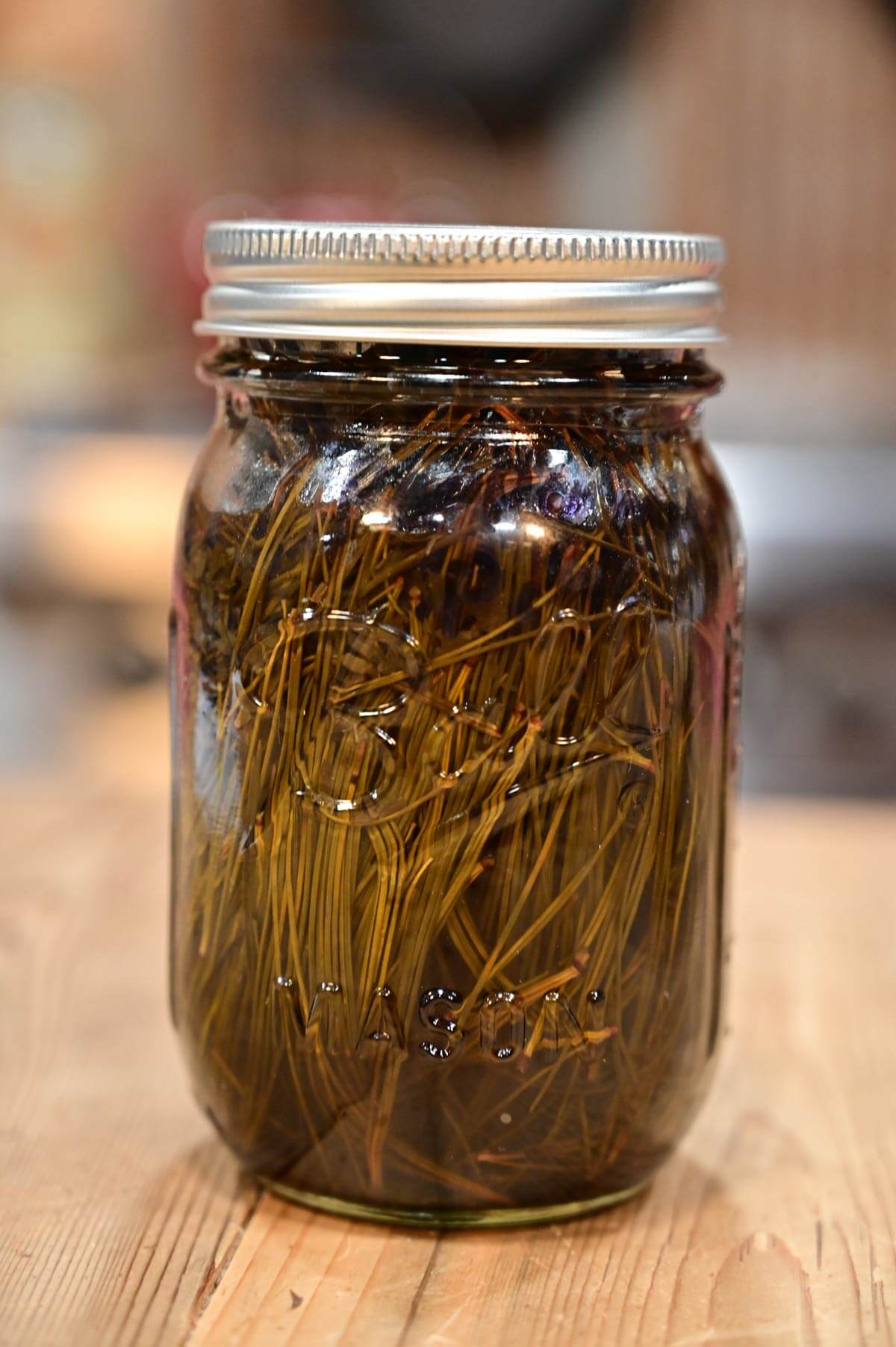 A pint-sized Mason jar filled with pine oil.