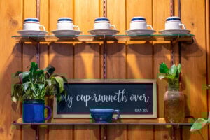 A coffee station with sign that reads, "My Cup Runneth Over."