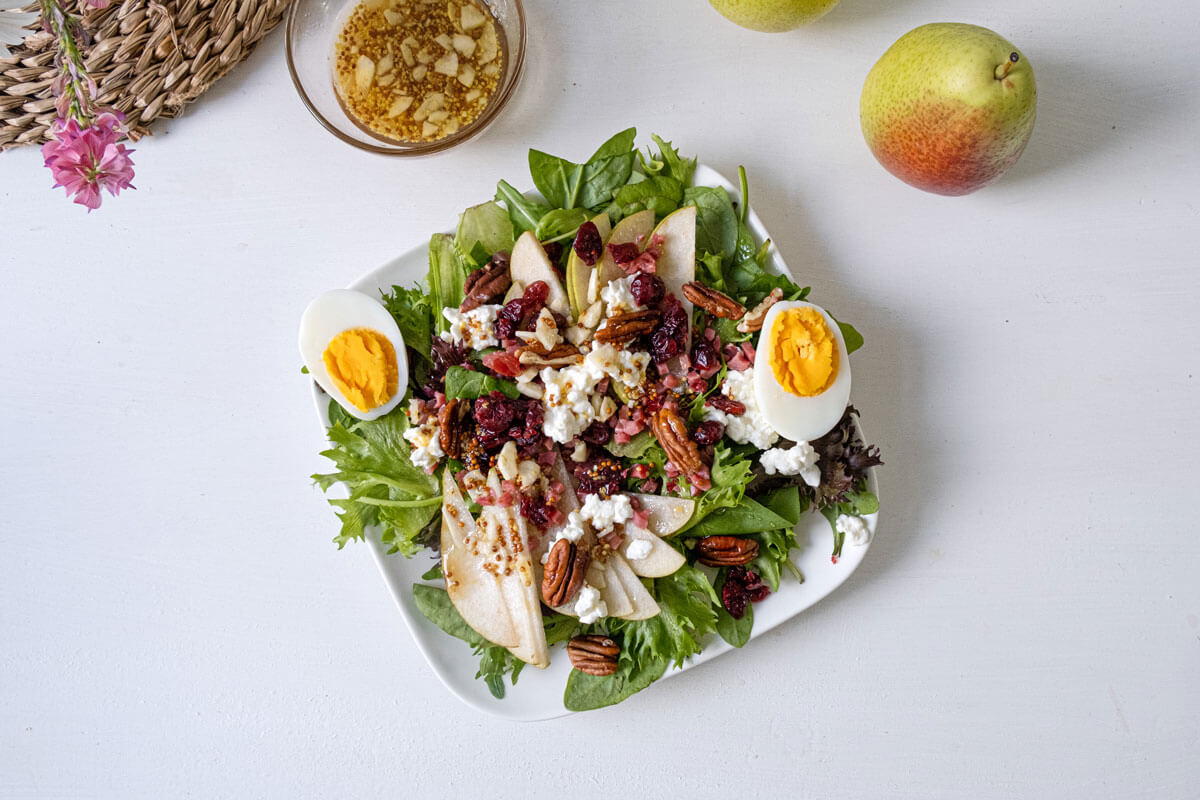 Overhead photo of pear salad on a white plate.