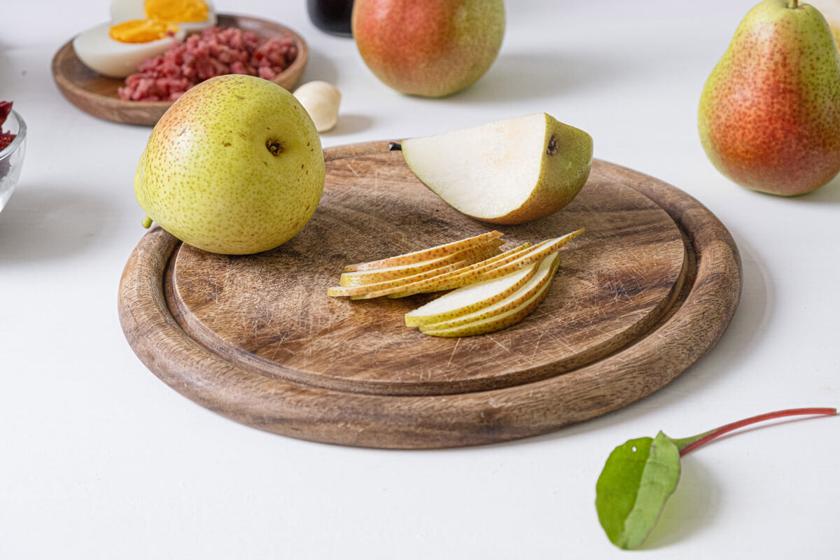 Sliced pears on a wooden cutting board.