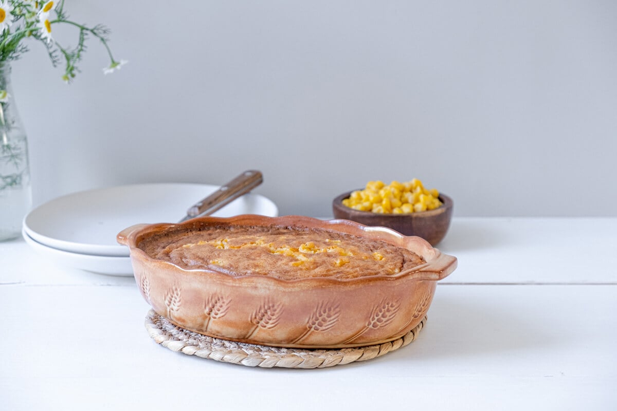 Corn pudding in a casserole dish.