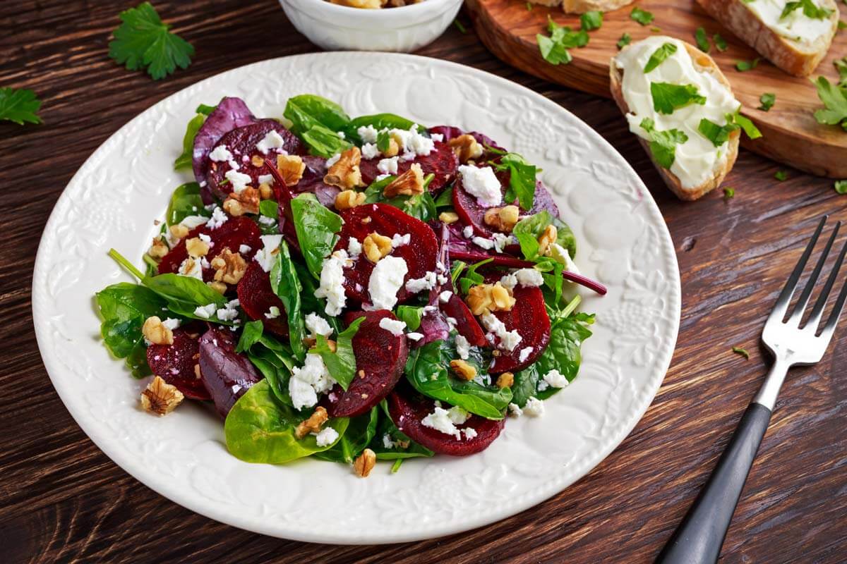 Beet salad with greens, nuts and cheese.