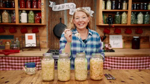 A woman with four different sauerkraut recipes.