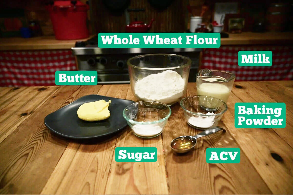 Whole wheat biscuit ingredients: flour, milk, baking powder, ACV, sugar, and butter