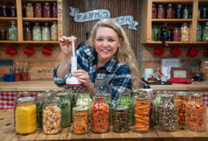 A woman vacuum sealing jars of freeze dried food.