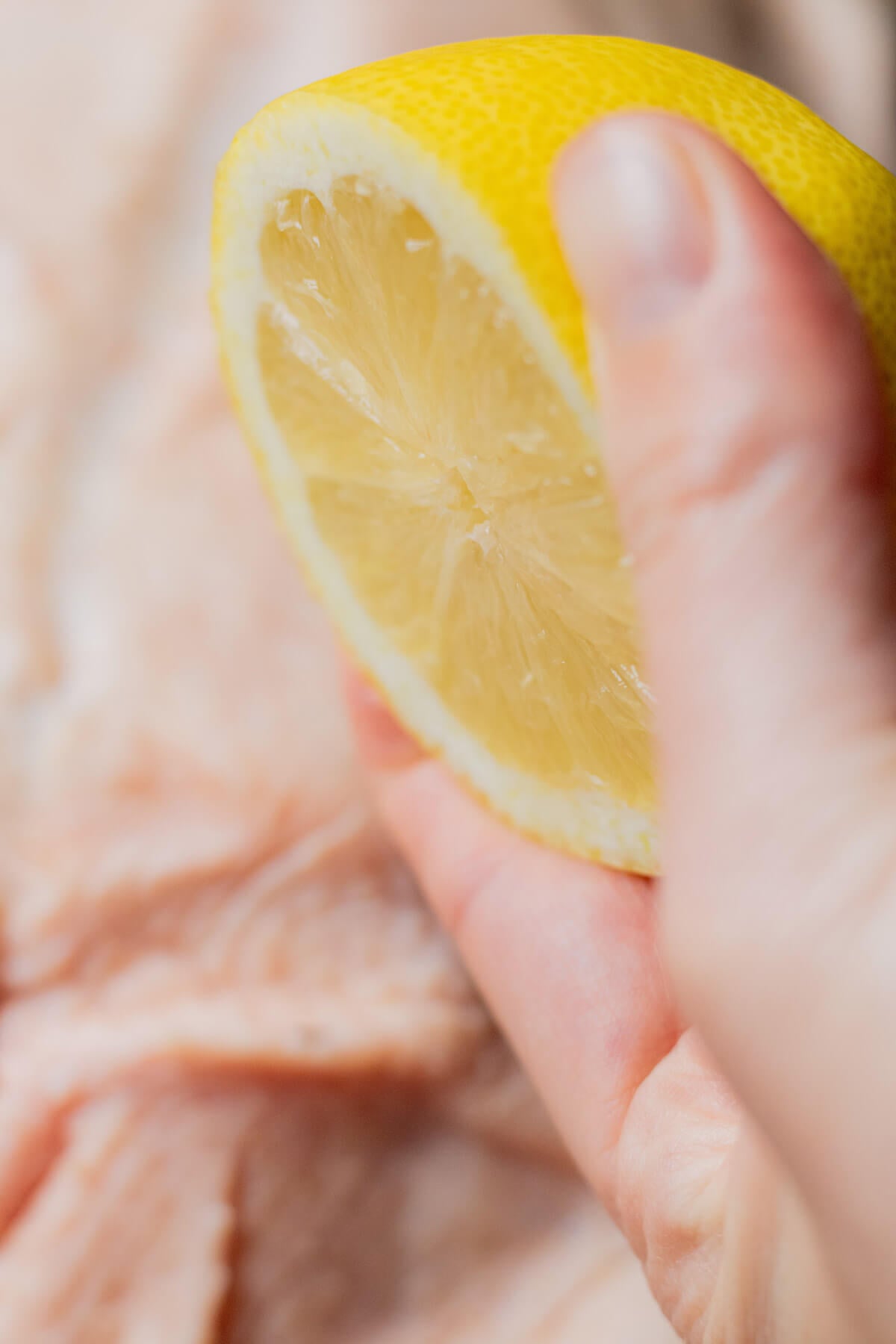Squeezing lemon juice over goose skin before roasting.
