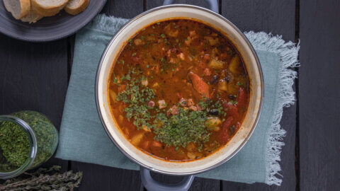 A pot of soup on a counter.