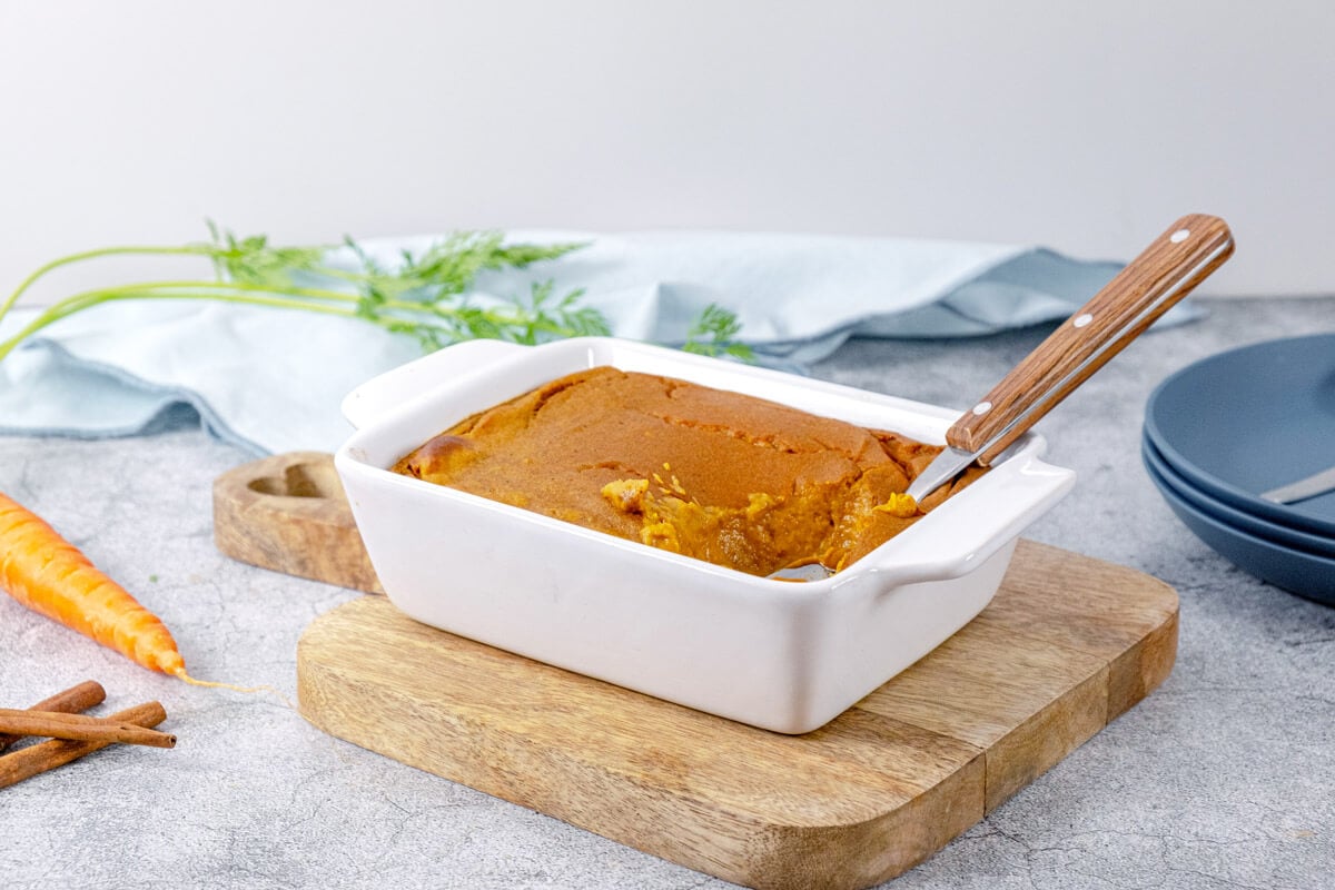 Finished carrot souffle in a white baking dish.