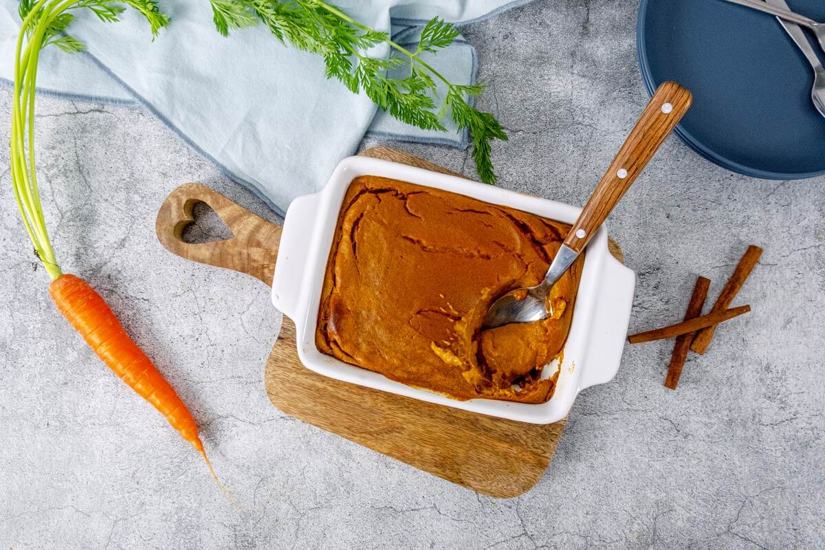 Finished carrot souffle in a white baking dish.
