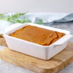 Finished carrot souffle in a white baking dish.