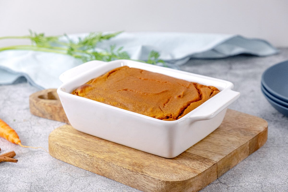 Finished carrot souffle in a white baking dish.