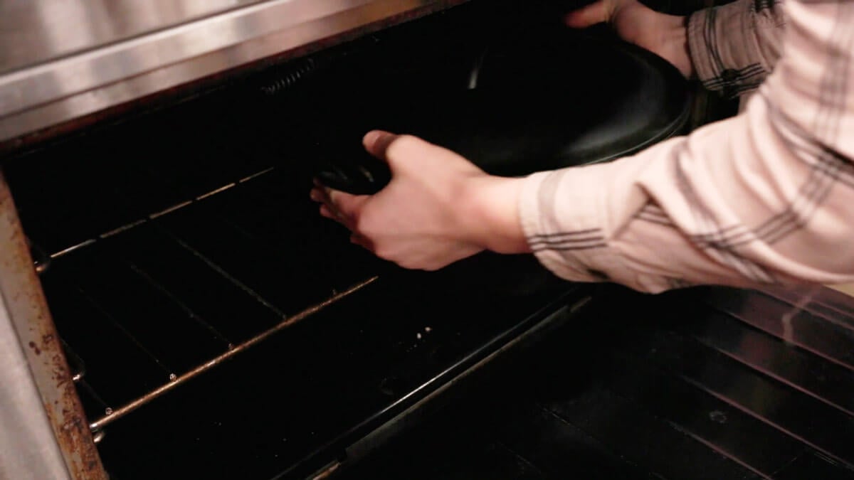 A pan being placed into the oven.