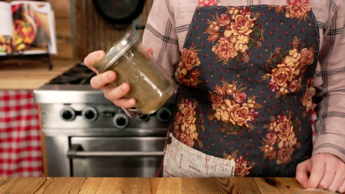 Poultry seasoning getting shaken up in a Mason jar.