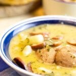 A bowl of sausage and kale soup.