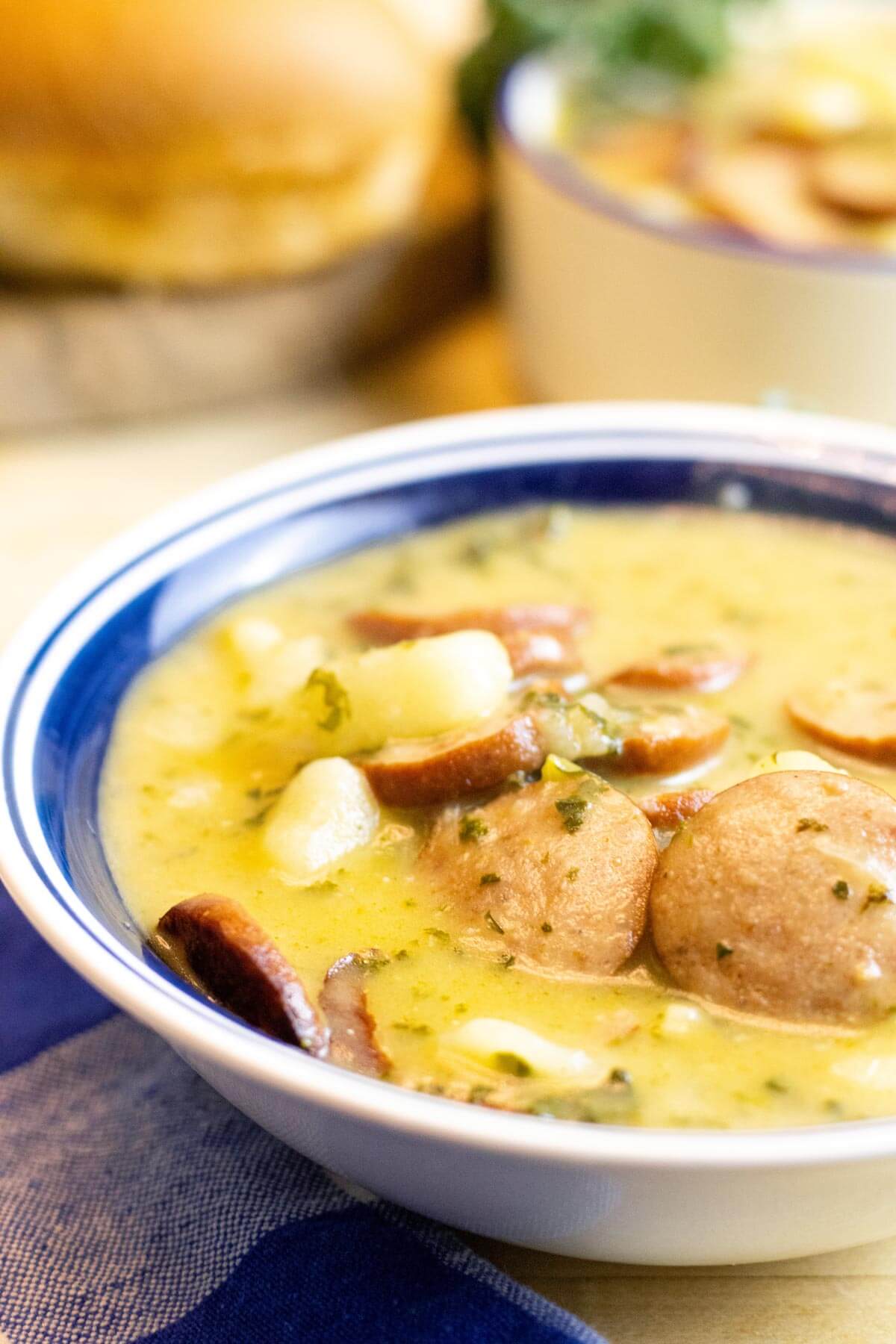 A bowl of sausage and kale soup.