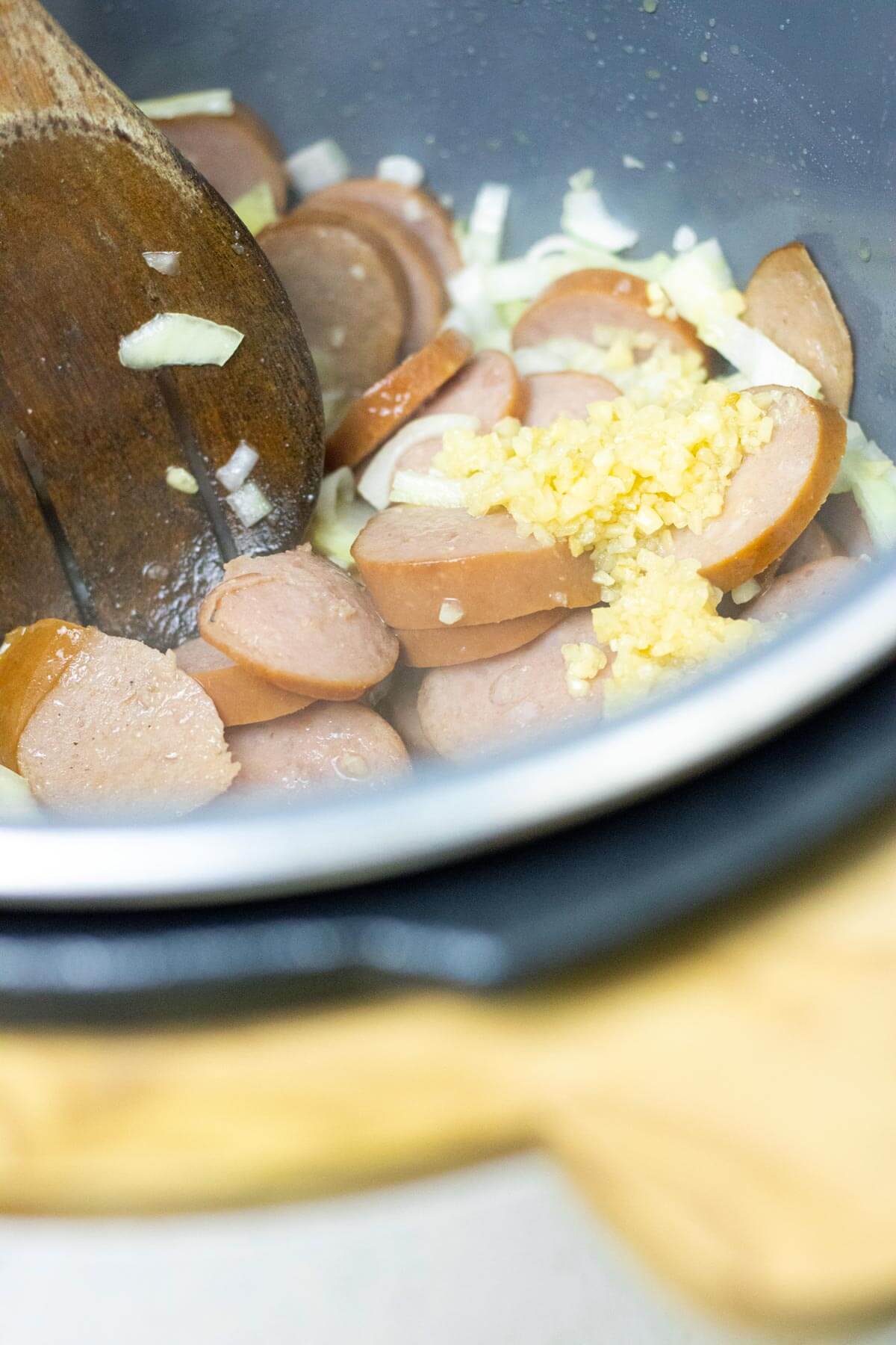 Sautéing garlic, onions, and sausage in the Instant Pot.