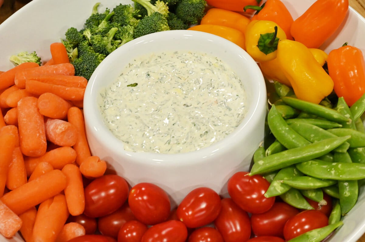 Homemade buttermilk ranch dressing in a bowl on veggie platter.
