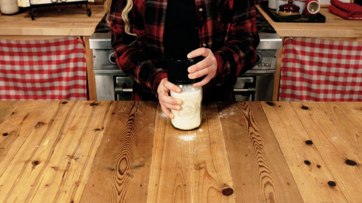 A Mason jar lid being sealed.
