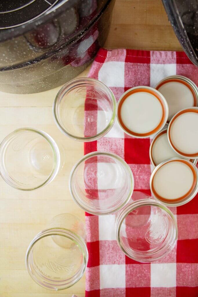 Washed jars, rings, and lids ready for canning.
