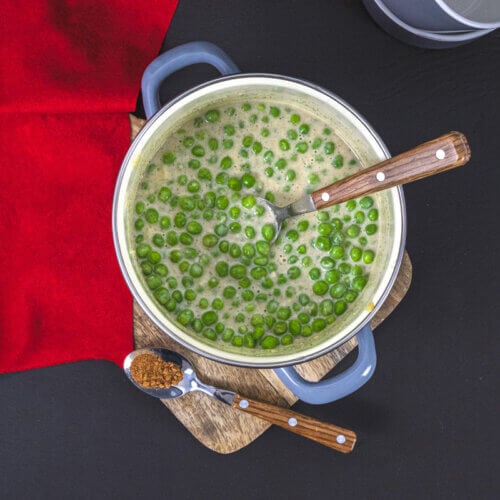 Overhead view of creamed peas in a Dutch Oven.