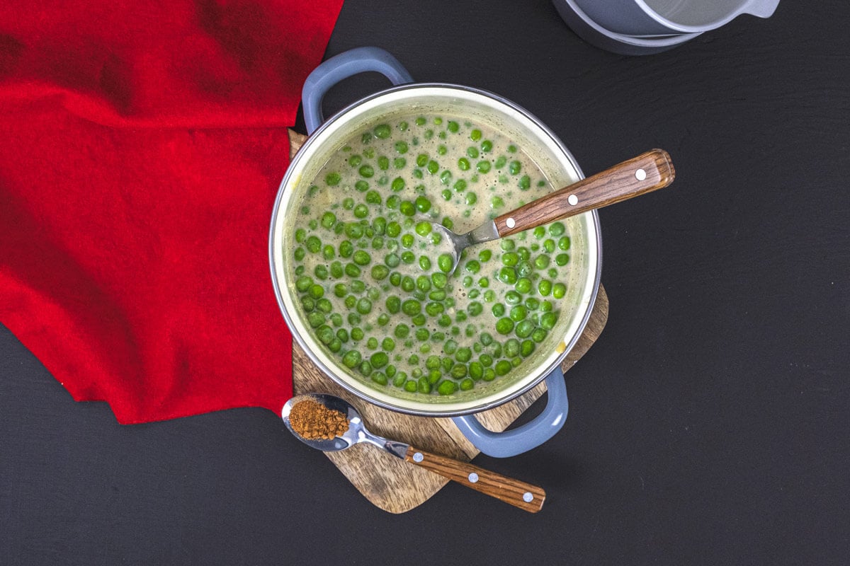 Overhead view of creamed peas in a Dutch Oven.