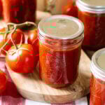 Home canned BBQ sauce in pint jars with bands removed.