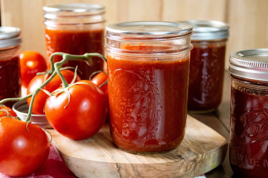 Home canned BBQ sauce in pint jars with bands removed.