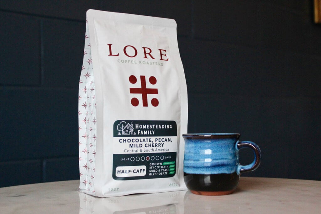 Bag of coffee with a coffee mug on a counter.