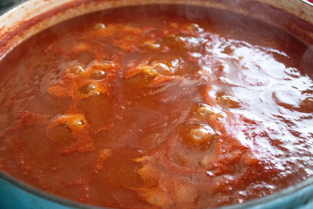 Homemade BBQ sauce simmering in a stock pot.