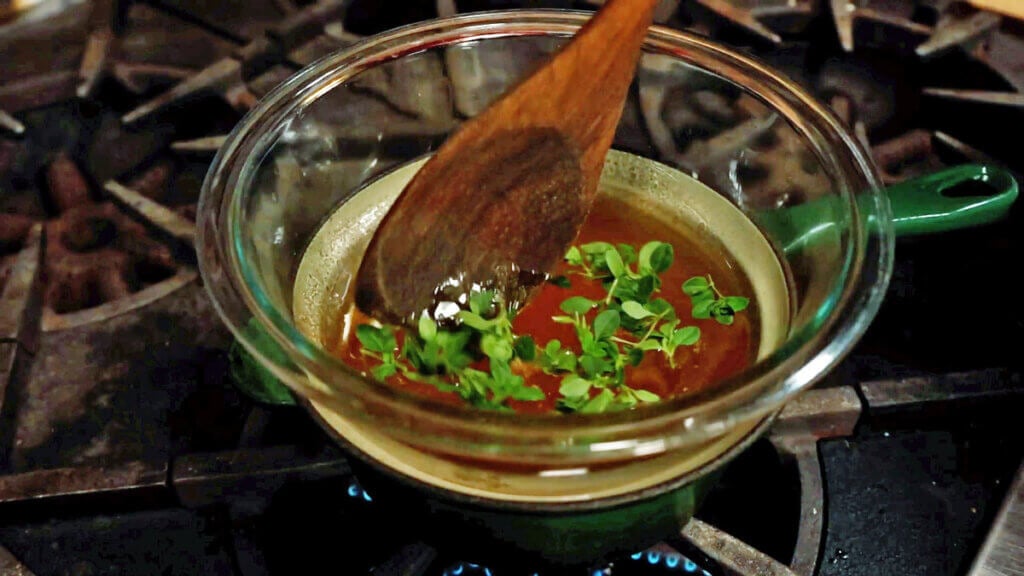 Herbal honey in a double boiler.