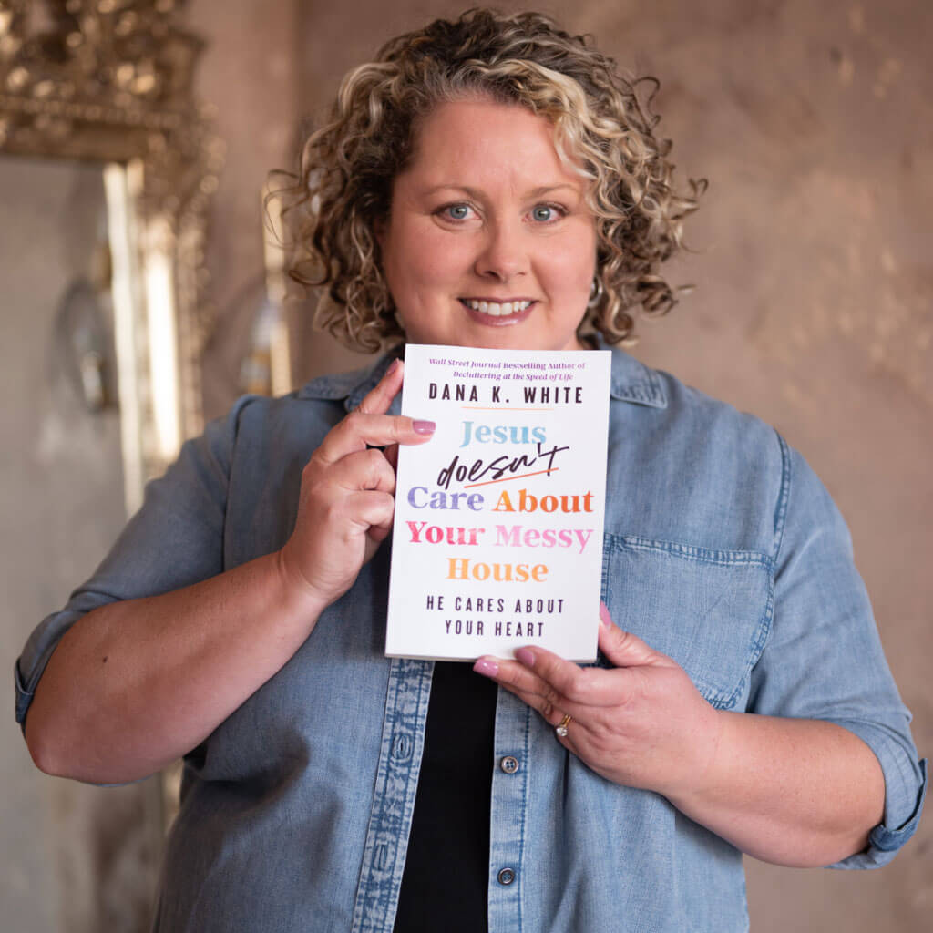 A woman holding up a book.