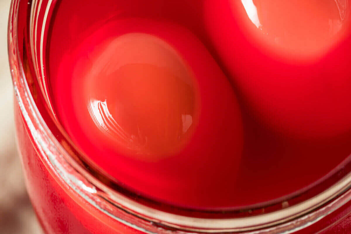 Pink pickled eggs in a jar.