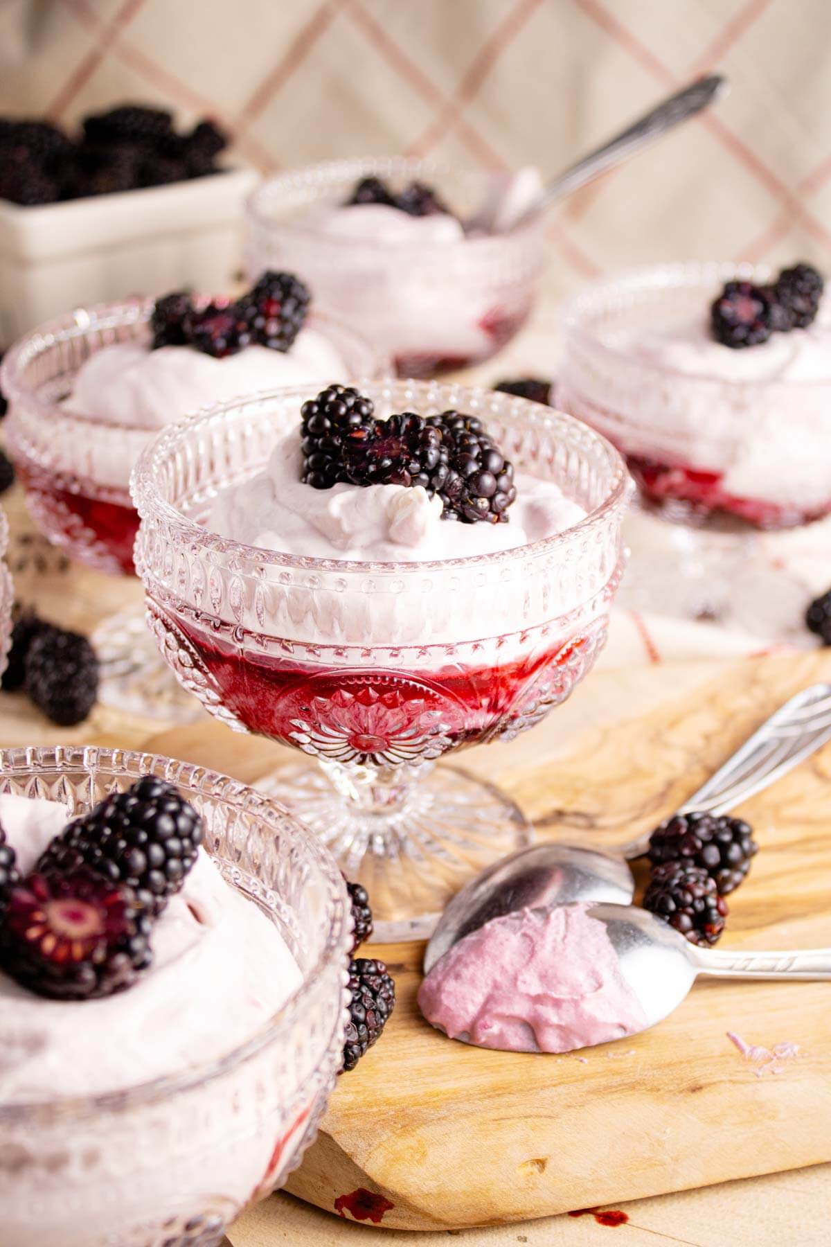 Blackberry fool served in stemware and garnished with fresh blackberries.