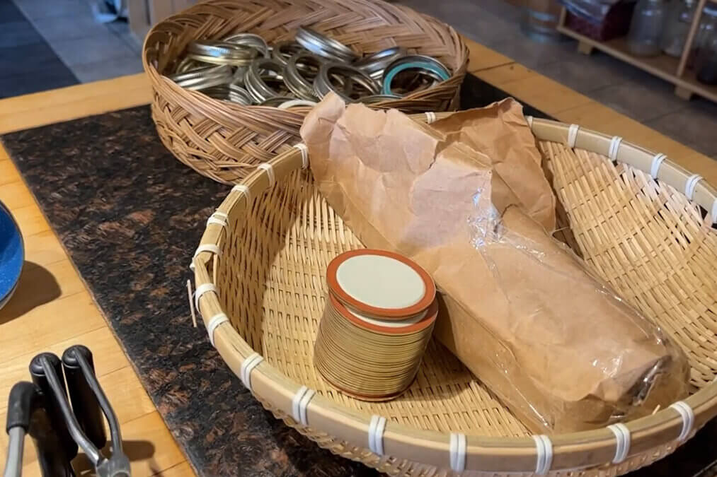 Two baskets with canning lids and bands.