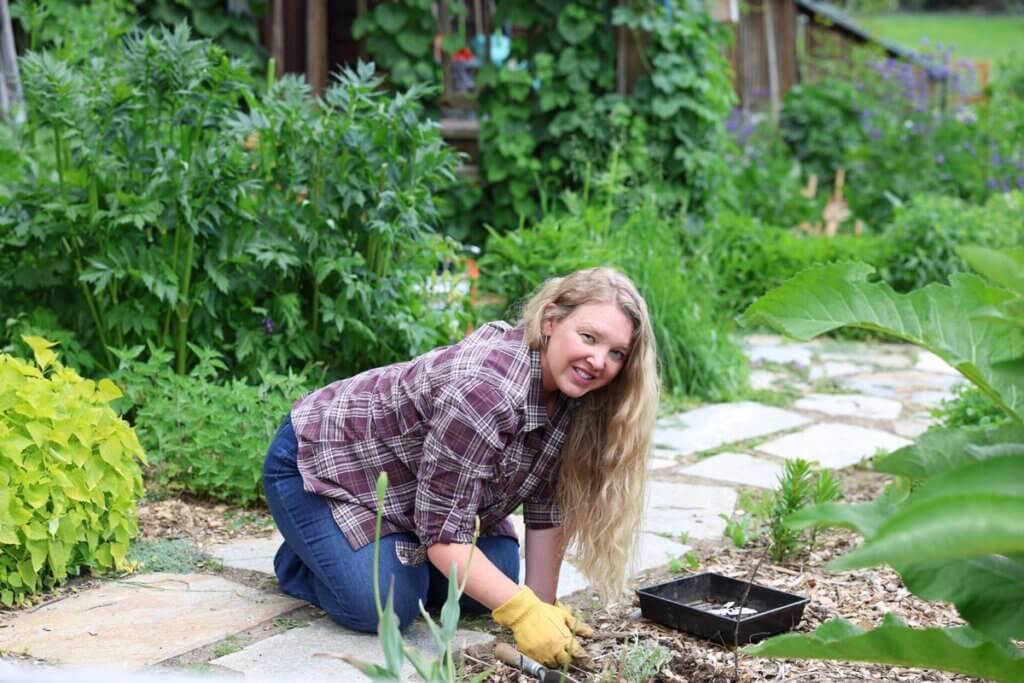A woman planting in the garden.