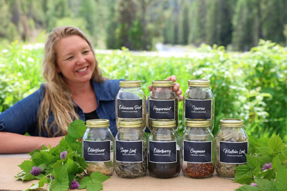 A woman with multiple jars of dried medicinal herbs.