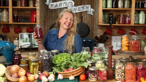 A counter full of preserved food and fresh garden harvests.