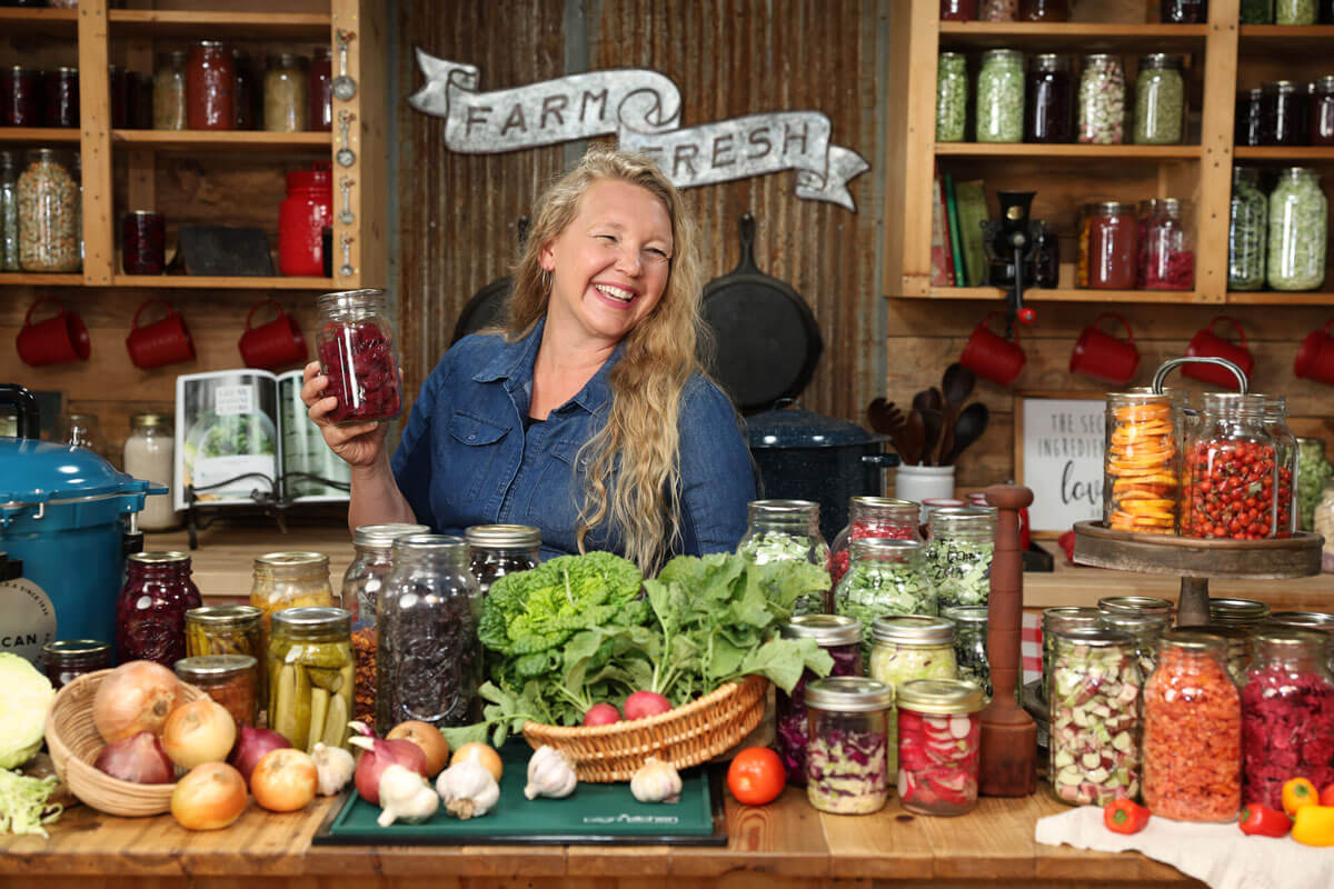 A counter full of preserved food and fresh garden harvests.