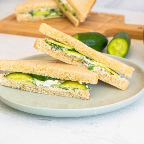 A cucumber sandwich served on a gray plate.
