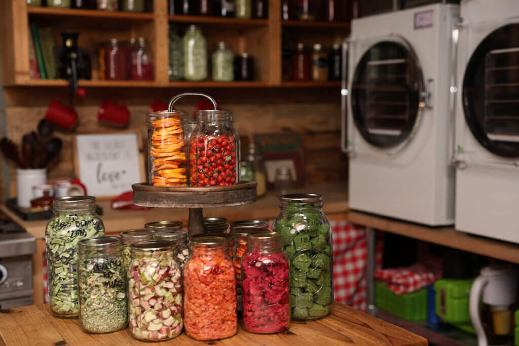 A counter full of jars of freeze dried food.