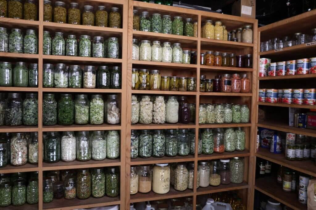 A food storage pantry filled with jars of preserved food.
