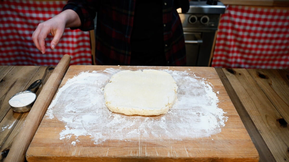 Homemade pie crust on a floured cutting board.