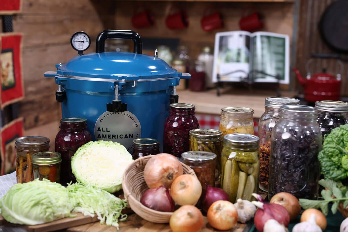 A counter full of preserved food and fresh garden harvests.
