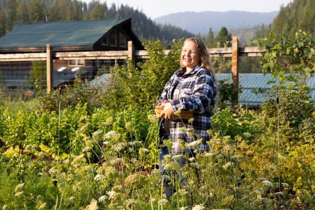 A woman harvesting crops in the garden.