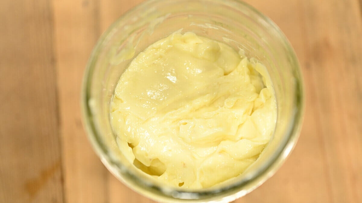Homemade mayonnaise in a glass Mason jar.