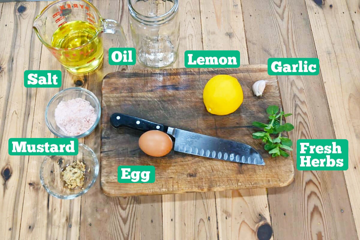 Healthy mayonnaise ingredients: oil, lemon, herbs, egg, garlic, and salt.