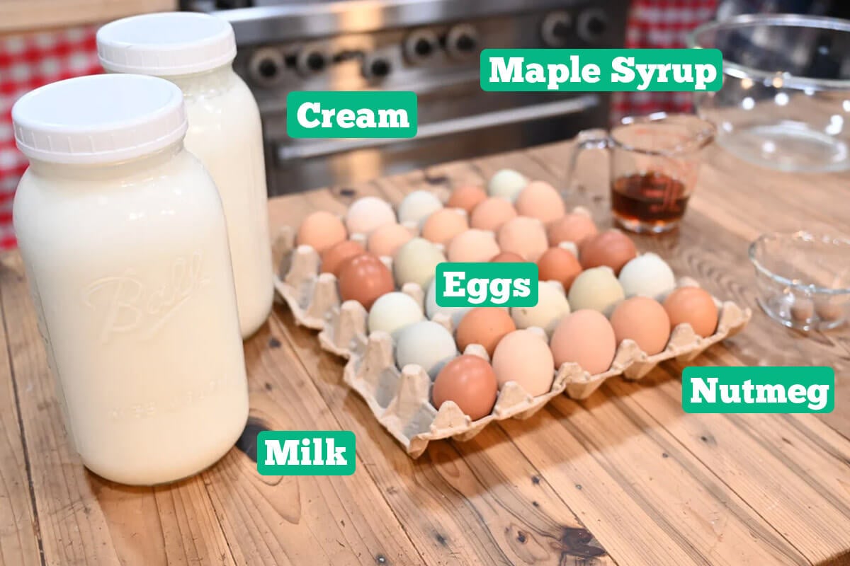 Homemade eggnog ingredients: eggs, maple syrup, milk, cream, and nutmeg.