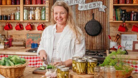 A woman canning pickles.