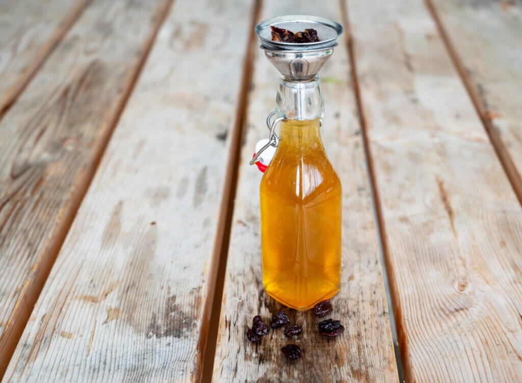 Straining cherries after kombucha has finished the second ferment process.